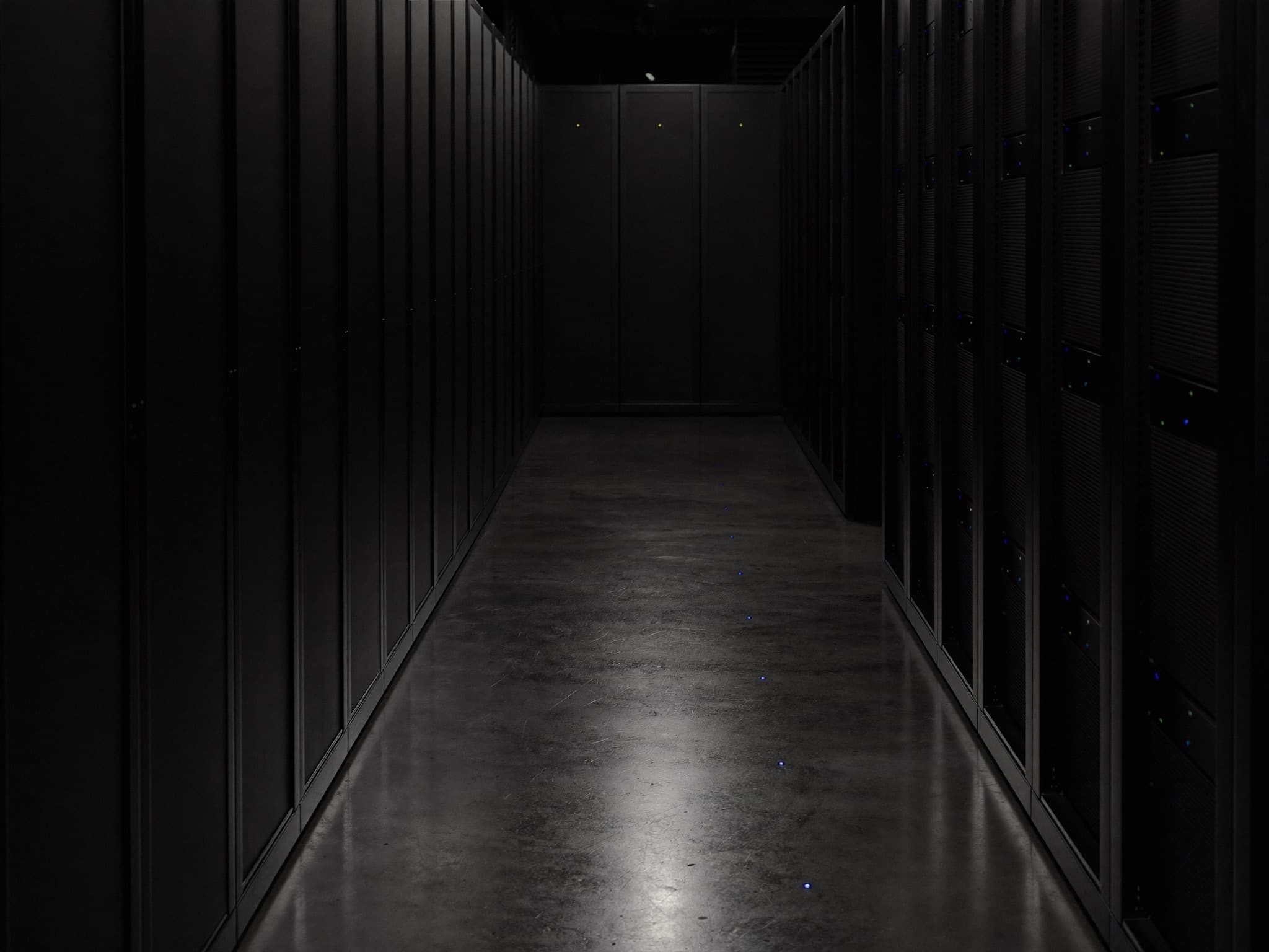 Dark server room corridor lined with racks